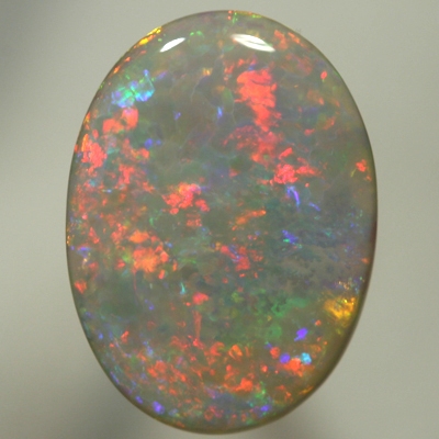 SOLID SEMI BLACK OPAL Large opal, red to blue to greens with a hint of gold. SEE VIDEO